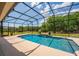 A screened pool features fountains, landscape, and room for relaxing in the backyard at 3733 Statham Dr, Apopka, FL 32712