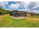 A fenced-in pool and patio area is surrounded by a well-maintained lawn and landscaping at 3733 Statham Dr, Apopka, FL 32712