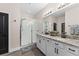 Bright bathroom featuring double vanity, granite countertops, and a glass-enclosed shower at 3733 Statham Dr, Apopka, FL 32712