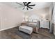 Serene bedroom with wood-look tile flooring, ceiling fan, neutral colors and bright natural light at 3733 Statham Dr, Apopka, FL 32712