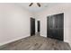 Bright bedroom with hard surface floors and closet with black doors at 3733 Statham Dr, Apopka, FL 32712
