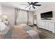 Comfortable bedroom featuring an outdoor entry, ceiling fan, wood-look floors and a neutral palette at 3733 Statham Dr, Apopka, FL 32712