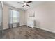 Bedroom with wood-like tile flooring and natural light at 3733 Statham Dr, Apopka, FL 32712