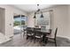Cozy dining area with a view of the pool through sliding glass doors and modern light fixtures at 3733 Statham Dr, Apopka, FL 32712