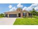 Charming single Gathering home with a well-manicured lawn, two car garage and beautiful landscaping at 3733 Statham Dr, Apopka, FL 32712