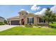 Charming single-story home with a manicured lawn and dark accents at 3733 Statham Dr, Apopka, FL 32712