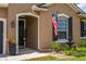 Front porch with garden and American flag at 3733 Statham Dr, Apopka, FL 32712