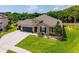 Beautifully landscaped front yard with a charming home, featuring a two-car garage, and a well-kept lawn at 3733 Statham Dr, Apopka, FL 32712