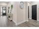 Inviting hallway with tiled flooring and a decorative console table at 3733 Statham Dr, Apopka, FL 32712
