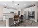 Modern kitchen with white cabinets, an island with bar seating, and stainless steel appliances at 3733 Statham Dr, Apopka, FL 32712