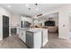 Bright kitchen features a center island, stainless appliances, and an open layout to the living room at 3733 Statham Dr, Apopka, FL 32712