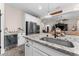 Beautiful kitchen island with stainless sink, granite counters, mini-fridge, and views to the living room at 3733 Statham Dr, Apopka, FL 32712