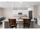Bright kitchen featuring a large island with seating, pendant lighting, and stainless steel appliances at 3733 Statham Dr, Apopka, FL 32712