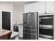 The kitchen has modern stainless appliances, white cabinets, granite countertops and a built-in mini-fridge at 3733 Statham Dr, Apopka, FL 32712