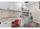 Bright laundry room with granite countertops, modern appliances, and ample storage at 3733 Statham Dr, Apopka, FL 32712