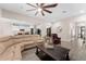 Open-concept living area with wood-look tile, neutral walls, and a view into the kitchen at 3733 Statham Dr, Apopka, FL 32712