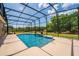 A screened-in pool offers the perfect outdoor retreat with lush greenery visible beyond the enclosure at 3733 Statham Dr, Apopka, FL 32712