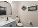 Stylish half bathroom with modern fixtures and decorative accents at 3733 Statham Dr, Apopka, FL 32712