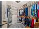Spacious walk-in closet with custom shelving, clothing racks, and a decorative rug at 3733 Statham Dr, Apopka, FL 32712