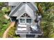 Aerial view of a home with a deck, outdoor seating, a grill, and surrounded by lush, mature landscaping at 421 W 10Th Ave, Mount Dora, FL 32757
