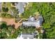 This aerial view shows the backyard pool, patio, lush landscaping, and private driveway of this luxurious property at 421 W 10Th Ave, Mount Dora, FL 32757