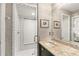Bathroom with glass shower, beautiful wallpaper, and granite countertops at 421 W 10Th Ave, Mount Dora, FL 32757