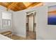 Walk-in closet showing ample built-in storage with natural wood beams in ceiling at 421 W 10Th Ave, Mount Dora, FL 32757