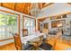 Bright dining room features a chandelier, glass table, and scenic views from the windows at 421 W 10Th Ave, Mount Dora, FL 32757