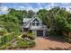 Charming two-story home with a spacious deck and a well-manicured front yard surrounded by lush greenery at 421 W 10Th Ave, Mount Dora, FL 32757