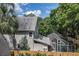 Back exterior of home with screened in pool and wood fence at 421 W 10Th Ave, Mount Dora, FL 32757