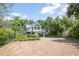 Charming home boasts a spacious driveway, lush landscaping, and a modern exterior at 421 W 10Th Ave, Mount Dora, FL 32757