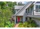 Charming home featuring a red front door with verdant landscaping and a brick walkway at 421 W 10Th Ave, Mount Dora, FL 32757