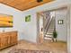 Hallway with beautiful tile floors, wood accents and staircase to the upper level at 421 W 10Th Ave, Mount Dora, FL 32757