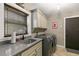 Well-lit laundry room featuring a sink, counter space, and modern appliances at 421 W 10Th Ave, Mount Dora, FL 32757
