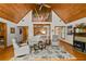 Open-concept living room featuring vaulted wood ceilings and a cozy fireplace at 421 W 10Th Ave, Mount Dora, FL 32757