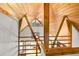 Bright loft featuring wooden beams and ceilings, white walls and railing that overlooks the downstairs dining area at 421 W 10Th Ave, Mount Dora, FL 32757