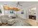 Spacious main bedroom featuring a beamed ceiling, fan, and ensuite bathroom at 421 W 10Th Ave, Mount Dora, FL 32757