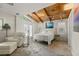 Comfortable main bedroom with vaulted wood ceilings and access to the outdoors at 421 W 10Th Ave, Mount Dora, FL 32757