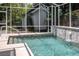 Backyard swimming pool with a screen enclosure and a fountain, offering a serene and private retreat at 421 W 10Th Ave, Mount Dora, FL 32757