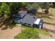 Aerial view of a home with a well-manicured lawn, screened patio, and mature landscaping at 43411 State Road 19, Altoona, FL 32702