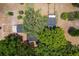 An aerial view showcases the well-maintained home, a big tree, and lush landscaping on this property at 43411 State Road 19, Altoona, FL 32702