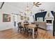 Modern dining area featuring wood table, decorative lighting, and barn door to bathroom at 43411 State Road 19, Altoona, FL 32702