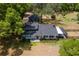 Aerial view of home with neutral exterior paint, mature landscaping and a screened-in porch at 43411 State Road 19, Altoona, FL 32702