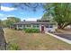 Charming one story home with green and red doors and mature landscaping at 43411 State Road 19, Altoona, FL 32702