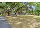 Sprawling front yard features large, mature shade trees and a long driveway leading up to the home at 43411 State Road 19, Altoona, FL 32702