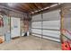 Garage interior features a large door, concrete floor, and door to outside at 43411 State Road 19, Altoona, FL 32702