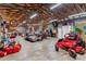 Spacious garage featuring ample storage, exposed wood beams, and a concrete floor perfect for projects at 43411 State Road 19, Altoona, FL 32702