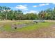 Exterior shot of a garden with new crops, hoses and a partially built green house at 43411 State Road 19, Altoona, FL 32702