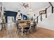 Open-concept living and dining area featuring hardwood floors, fireplace, and chandelier at 43411 State Road 19, Altoona, FL 32702