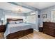 Spacious main bedroom featuring wood floors, recessed lights, with a large bed and matching furniture at 43411 State Road 19, Altoona, FL 32702